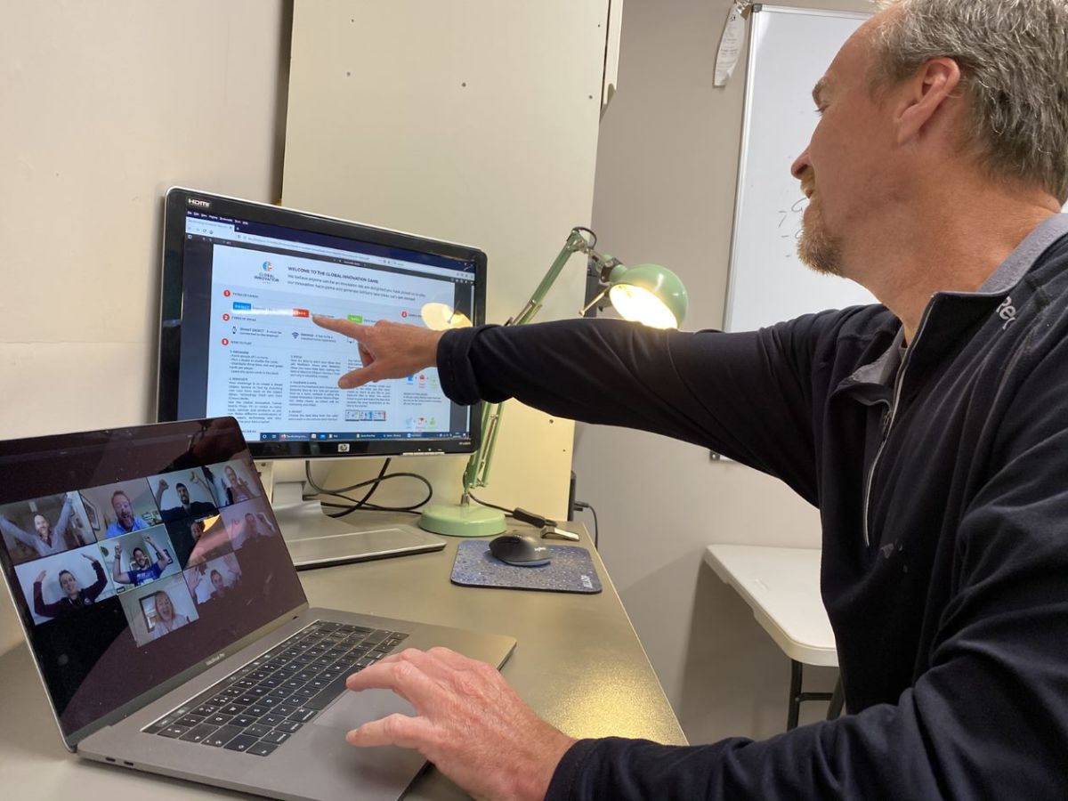 Man is playing Online teambuilding game called Global innovation game
