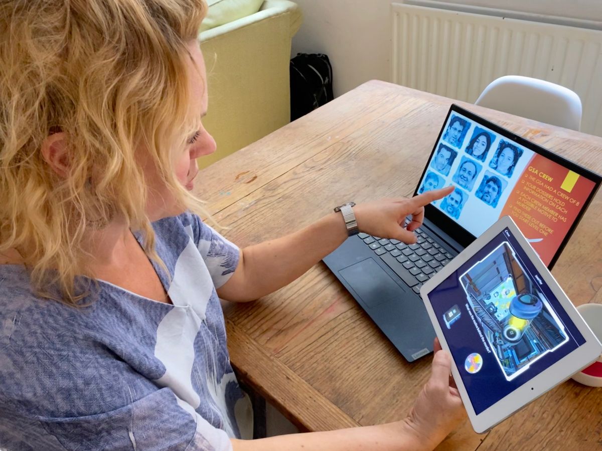 Woman plays Space Odyssey Online Teambuilding Game at Home with her notebook