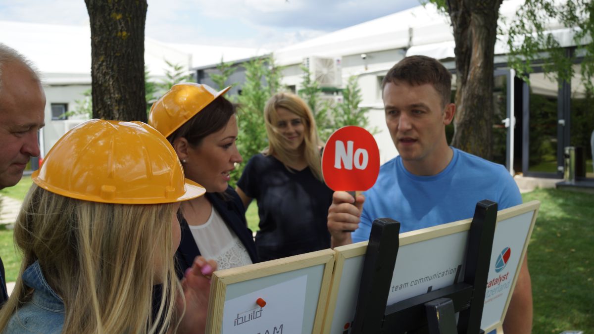 players debate about a challenge in the ibuild creative teambuilding game